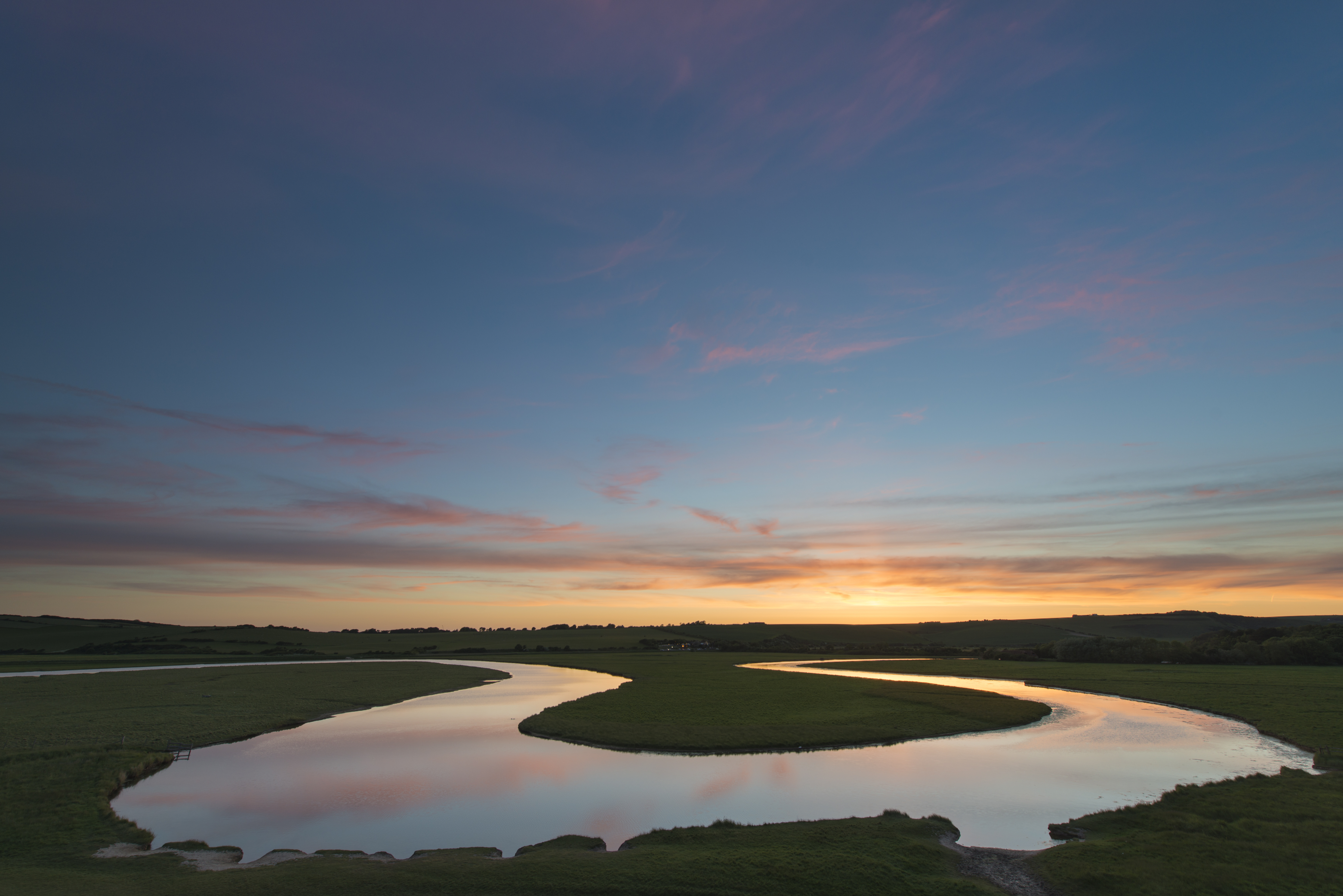 Sunset reflected in the meanders of the Cuckmere River, Cuckmere Valley, East Sussex.